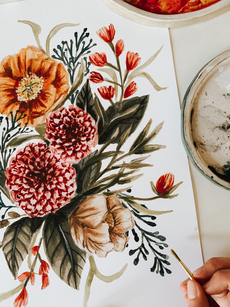 May include: A watercolour painting of a floral bouquet with red, orange, and brown flowers, green leaves, and a gold paintbrush.