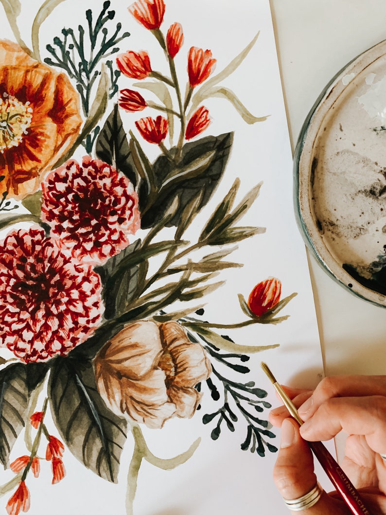 May include: A watercolour painting of a floral bouquet featuring red, orange, and white flowers. The bouquet is painted on a white background and includes green leaves and stems.