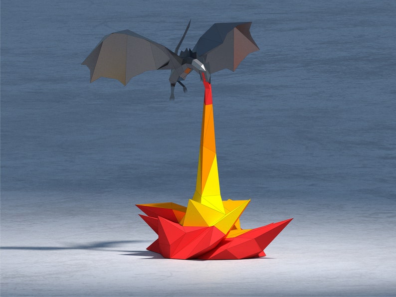 May include: A gray origami dragon with wings spread wide, breathing fire. The fire is a yellow and orange origami flame.