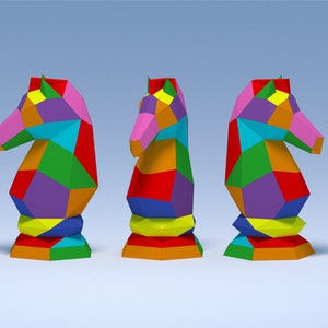 May include: Three colorful origami chess knight pieces made of paper. Each knight is a different color combination of red, orange, yellow, green, blue, purple, and pink.