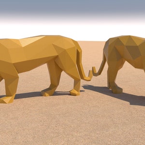 May include: Two golden origami lions standing on a sandy surface. The lions are facing different directions and have a polygonal design.