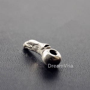 May include: Silver eagle head charm with a round bead, perfect for jewelry making or adding a unique touch to your crafts.