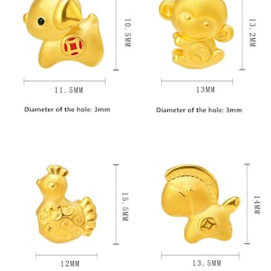 May include: Four gold-colored charms in the shape of a dog, monkey, chicken, and horse. Each charm has a red circle with a Chinese character in the center. The charms are approximately 1-2 inches in size.