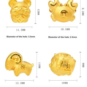 May include: Four gold-colored charms depicting the Chinese zodiac animals: rat, crab, ram, and pig. Each charm has a hole for attaching to a bracelet or necklace. The charms are approximately 1-1.5 inches in size.