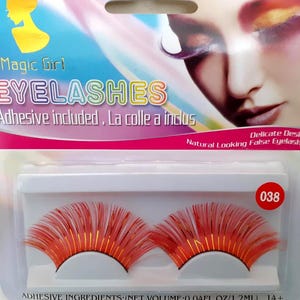May include: Package of Magic Girl eyelashes with adhesive. The false eyelashes are red and orange with a delicate design. The package includes the text "EYELASHES" and "Adhesive included". The product is labeled with the number "038".