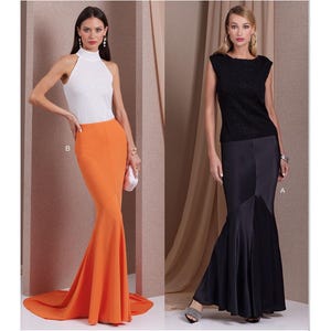 May include: Vogue Patterns V1986. The image shows two women modeling evening gowns. One gown is a white halter top with an orange mermaid skirt. The other is a black lace top with a black mermaid skirt. The Vogue Patterns logo is at the top.