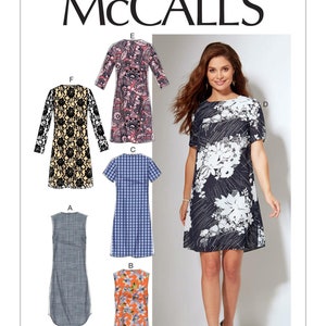 May include: McCALL'S M7533 sewing pattern featuring six variations of a dress. Designs include a black and white floral print, a black and gold lace pattern, a multi-colored floral print, a blue plaid, a solid grey fabric, and an orange floral print.
