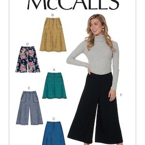 May include: McCall's sewing pattern M7475 featuring various skirt and pant designs. The image shows a woman wearing black wide-leg pants. The pattern includes options for a denim skirt, floral skirt, and other styles.