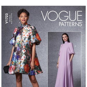 May include: Vogue Patterns sewing pattern for a dress with a high neck and puff sleeves. The pattern includes two variations: a short dress with a floral print and a long dress in a solid lavender colour. The pattern number is V1723.