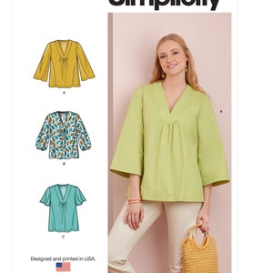 May include: Simplicity sewing pattern S9333 featuring a V-neck top with three variations: a solid mustard yellow version, a white version with a teal and brown leaf print, and a solid turquoise version with shorter sleeves and a gathered neckline.