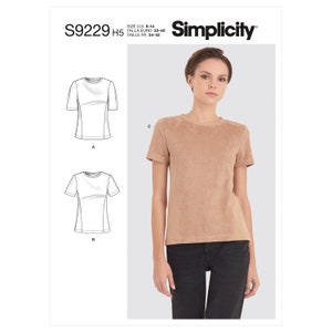 Könnte beinhalten: Ein hellbraunes T-Shirt mit kurzen Ärmeln und Rundhalsausschnitt. Das Shirt hat eine vertikale Nahtdetail an der Seite. Das Bild enthält auch ein Schnittmuster und das Simplicity-Logo. Größe DE 32-40.