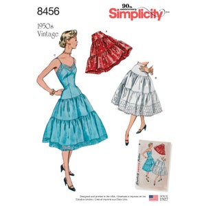 May include: Vintage Simplicity sewing pattern number 8456 for a 1950s style petticoat. The pattern includes three different styles: a red petticoat with a ruffled hem, a white petticoat with lace trim, and a blue petticoat with a ruffled hem.