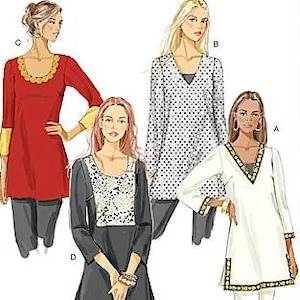 May include: Butterick B5390 Fast & Easy sewing pattern illustration featuring four tunic variations. Designs include a red tunic with yellow cuffs, a polka dot tunic, a black tunic with a white patterned bodice, and a white tunic with dark trim.