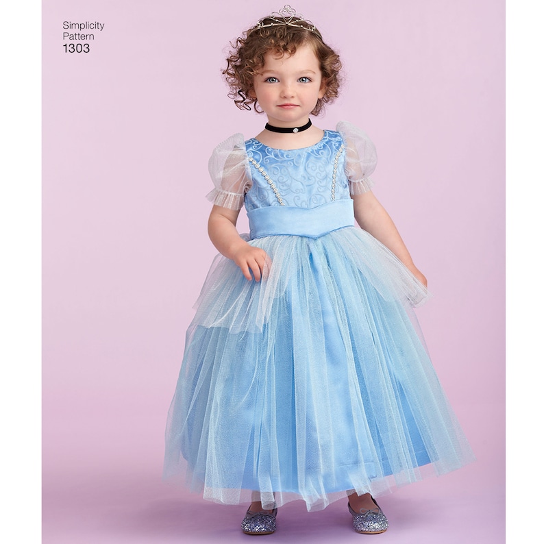 May include: A young girl wearing a light blue princess costume with a tulle skirt and a crown. The costume has a satin bodice with a floral pattern and a black choker.