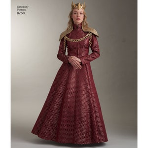 May include: A woman wearing a red and gold dress with a gold crown and a gold chain necklace. The dress has a pattern of small circles. Simplicity Pattern 8768.
