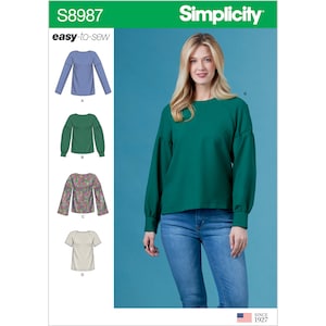 May include: Simplicity S8987 easy-to-sew pattern envelope featuring four top variations. The main image shows a long-sleeve green top with raglan sleeves and cuffs. Illustrations show a blue top, a green top, a floral print top, and a short-sleeve beige top.