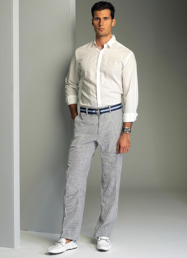 May include: A white button-down shirt with a striped pattern and a blue and white striped belt. The man is wearing white shoes.