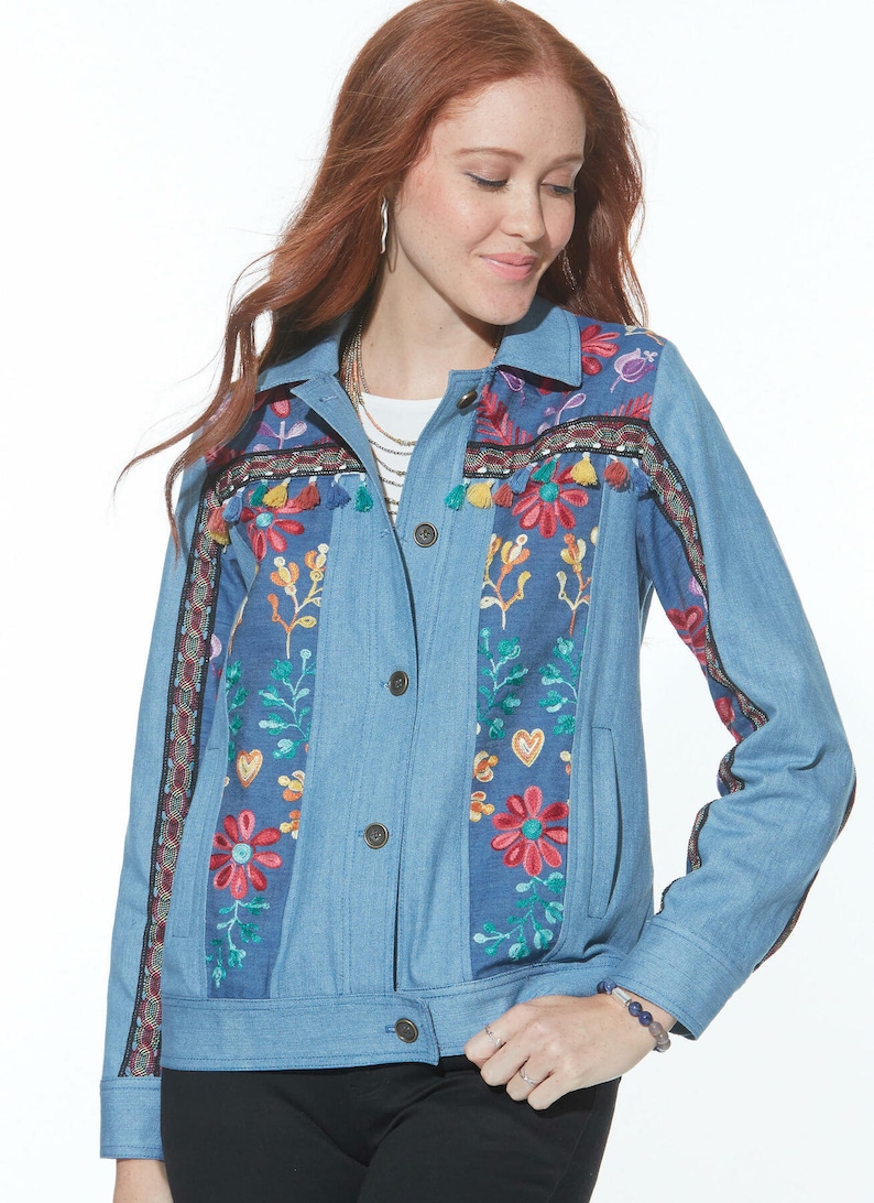 May include: A light blue denim jacket with colorful embroidered flowers and tassels. The jacket has a button closure and long sleeves.