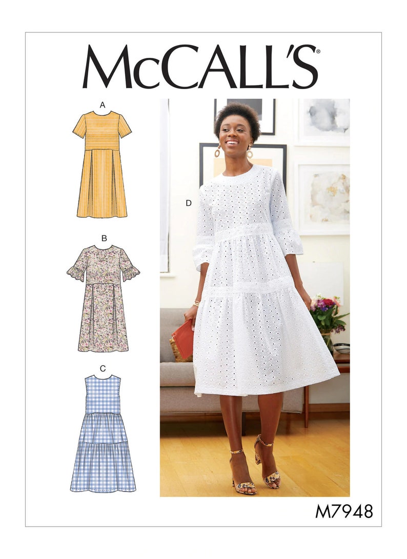 May include: McCall's sewing pattern featuring four dress designs. One dress is white with eyelet details, and the others are illustrated in yellow, floral, and blue gingham fabrics. The pattern number is M7948.