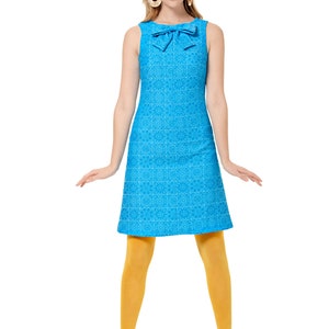 May include: A sleeveless blue dress with a white pattern and a bow at the neckline. The dress is fitted at the waist and flares out slightly at the hem. The model is wearing yellow tights and blue shoes.