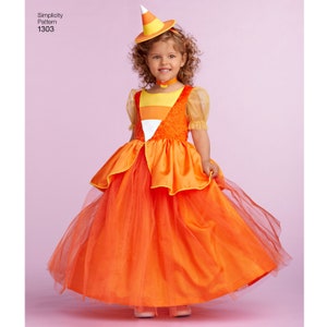 May include: A child wearing a candy corn costume with a matching hat. The costume is orange, yellow, and white and features a tulle skirt. The hat is a cone shape with a white tip and orange and yellow stripes.