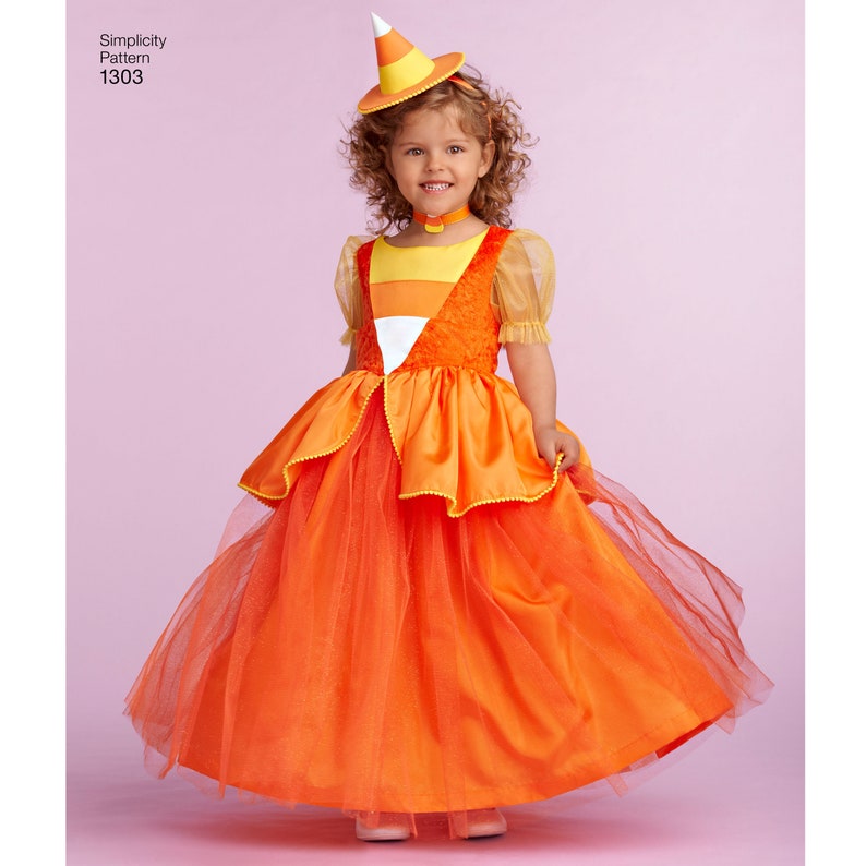May include: A child wearing a candy corn costume with a matching hat. The costume is orange, yellow, and white and features a tulle skirt. The hat is a cone shape with a white tip and orange and yellow stripes.