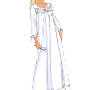 May include: A white nightgown with lace trim around the neckline and cuffs. The nightgown has a gathered bodice and a flowing skirt. The model is wearing the nightgown and holding a hairbrush.