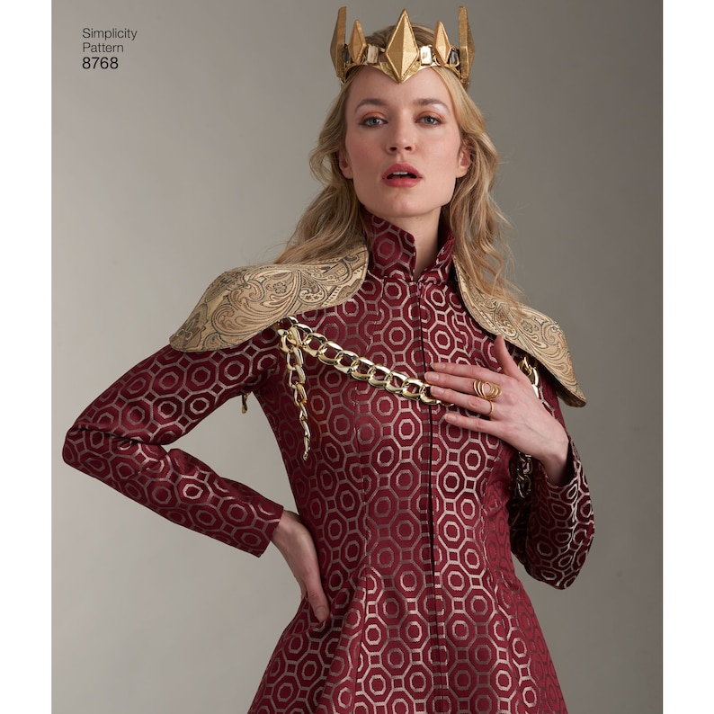 May include: A woman wearing a red and gold patterned dress with a gold chain and shoulder pads. She is wearing a gold crown with pointed spikes.