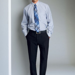 May include: A man wearing a blue and white striped dress shirt with a blue and black patterned tie. He is wearing black pants and black shoes.