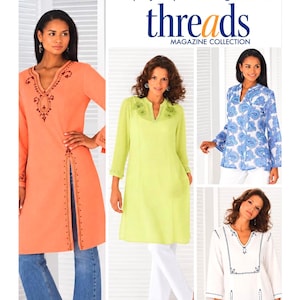 May include: Simplicity sewing pattern 4528 for tunics, featuring four variations: a long orange tunic with embroidery, a lime green tunic, a blue and white paisley print tunic, and a white tunic with black embroidery, all with long sleeves.