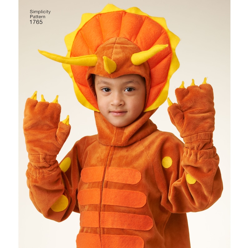 May include: A child wearing an orange and yellow dinosaur costume with a hood and matching gloves. The costume features a triceratops head with horns and a frill. Simplicity Pattern 1765.
