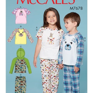 May include: McCall's M7678 pattern for children's pajamas. The image shows a variety of pajama designs, including a pink top with butterfly sleeves, a yellow top with a bear face, and a green hooded top with dinosaur print. The children are wearing pajama sets.