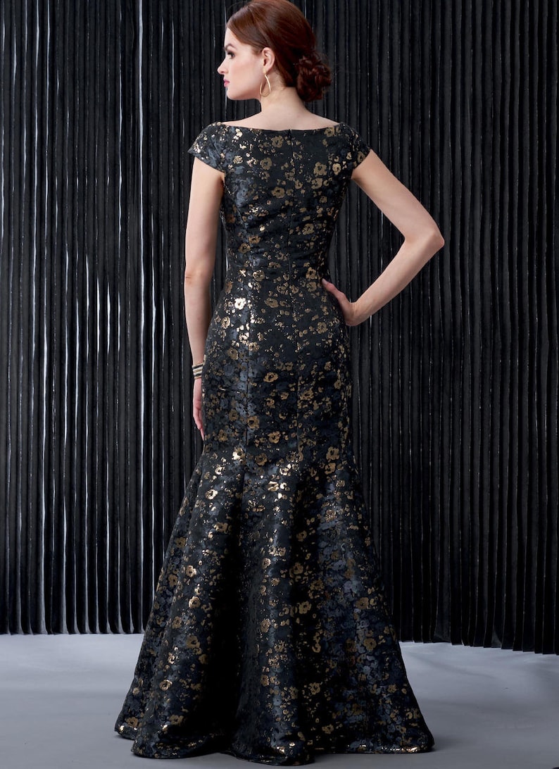 May include: A black and gold floral print dress with a fitted bodice and a flowing mermaid skirt.