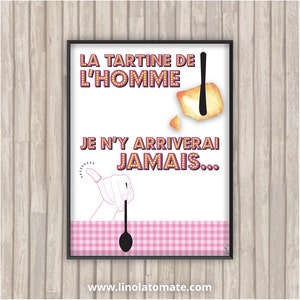 May include: Framed art print with the text "LA TARTINE DE L'HOMME JE N'Y ARRIVERAI JAMAIS..." in a retro font. The image includes a slice of toast with butter, a knife, and a hand with a spoon. The bottom has a pink gingham pattern.