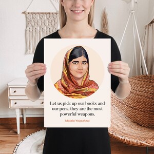 May include: A motivational quote by Malala Yousafzai, a Pakistani activist for female education, is printed on a white background. The quote reads: "Let us pick up our books and our pens, they are the most powerful weapons." The quote is surrounded by a circle with a cartoon illustration of Malala Yousafzai wearing a headscarf.