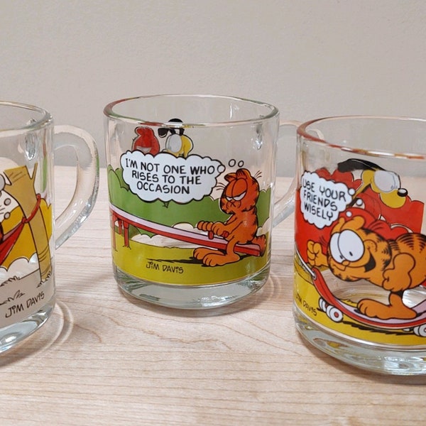 1978 Jim Davis Anchor Hocking McDonalds Garfield & Odie Mug | Choose From:  In Hammock, On A Teeter/Totter, Or On a Skateboard