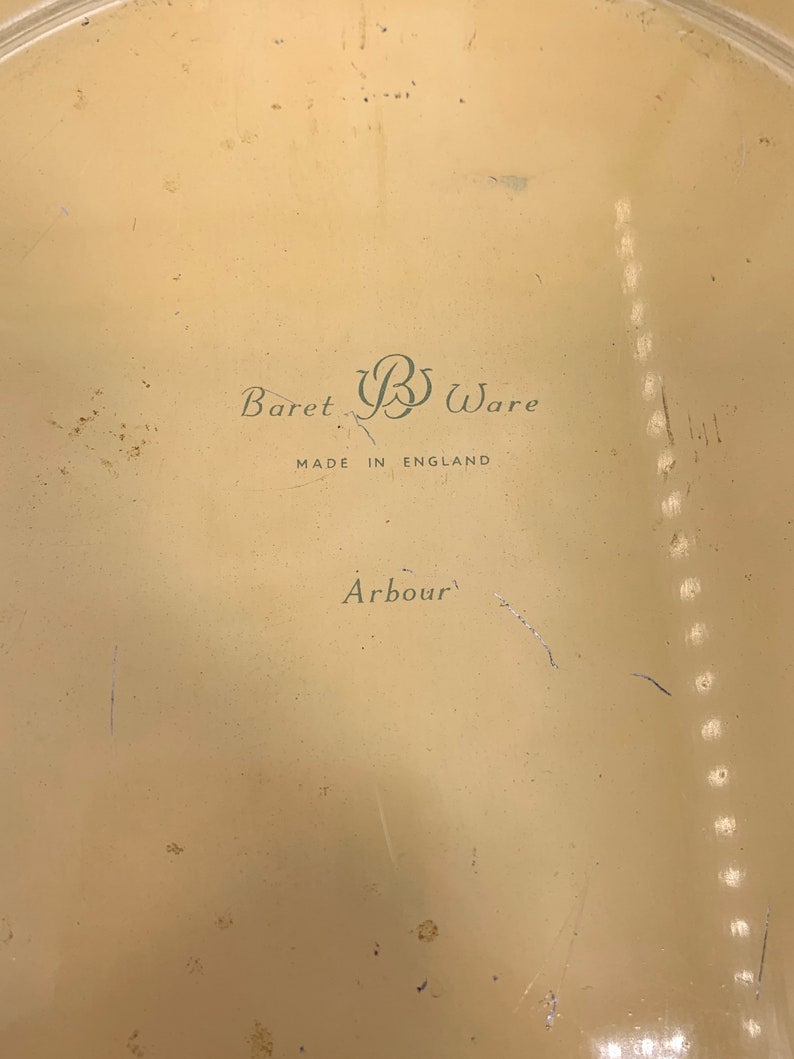 May include: A cream-colored metal tray with the text "Baret B Ware Made in England Arbour" printed on the bottom.