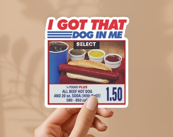 May include: A sticker featuring a hot dog with condiments, a soda, and the text "I GOT THAT DOG IN ME." The image includes a ¼ pound all-beef hot dog and a 20 oz. soda.