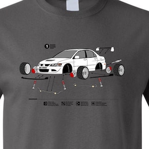 May include: A dark grey t-shirt featuring a white outline of a car with a step-by-step guide on how to install a suspension system. The text on the shirt reads "1. Remove the stock suspension components. 2. Install the new suspension components. 3. Torque the suspension components to the specified torque. 4. Test drive the vehicle. 5. Enjoy your new suspension!"