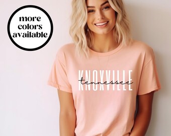 May include: A peach-colored t-shirt with the text "KNOXVILLE Tennessee" printed in white on the front.