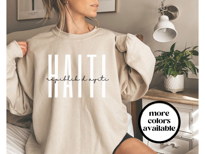 May include: A beige sweatshirt with the text "HAITI" in white and the words "Repiblik d Ayiti" in black script underneath.