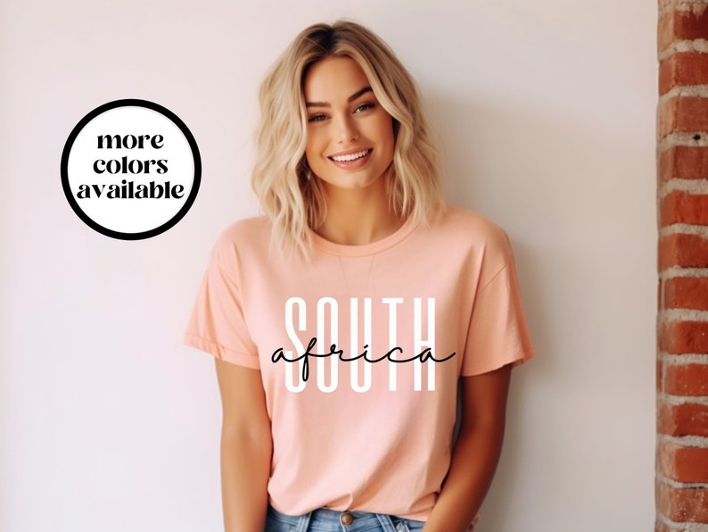 May include: A peach-coloured t-shirt with the text "SOUTH africa" in white and black lettering.