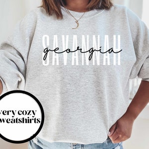 May include: A gray sweatshirt with the text "SAVANNAH georgia" in white and black lettering.