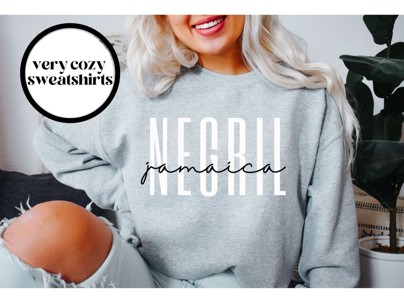 May include: Gray sweatshirt with the text "NEGRIL jamaica" in white letters.