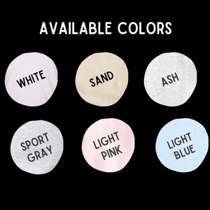 May include: Six fabric swatches in different colors: white, sand, ash, sport gray, light pink, and light blue. The swatches are arranged in two rows of three. The text "AVAILABLE COLORS" is above the swatches.