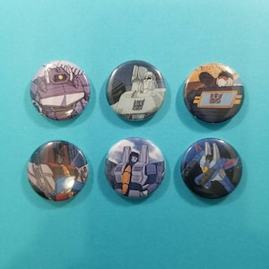 More than meets the eye! Set of 6 Transformers refrigerator  magnets featuring the Decepticons from the 80s cartoon series. One inch magnets