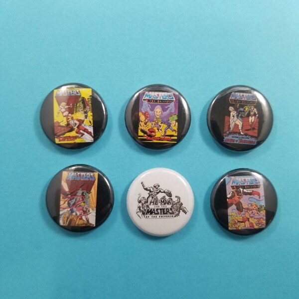 He-Man and the Masters of the Universe! Set of 6 pin back buttons badges pins featuring mini comics covers and a MOTU logo.