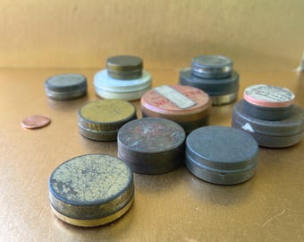 Set of 12 vintage round watch parts tins.