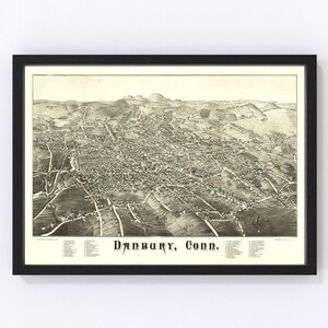 May include: A vintage black and white bird's eye view map of Danbury, Connecticut. The map shows the city's layout with streets, buildings, and surrounding hills. The text "Danbury, Conn." is printed in a decorative font at the bottom of the map.
