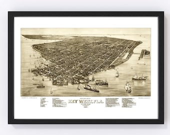 May include: An antique map of Key West, Florida, showing the city's layout and surrounding waters. The map is in sepia tones and features a detailed view of the city's streets, buildings, and harbour. The text "KEY WEST, FLA." is prominently displayed at the bottom of the map.